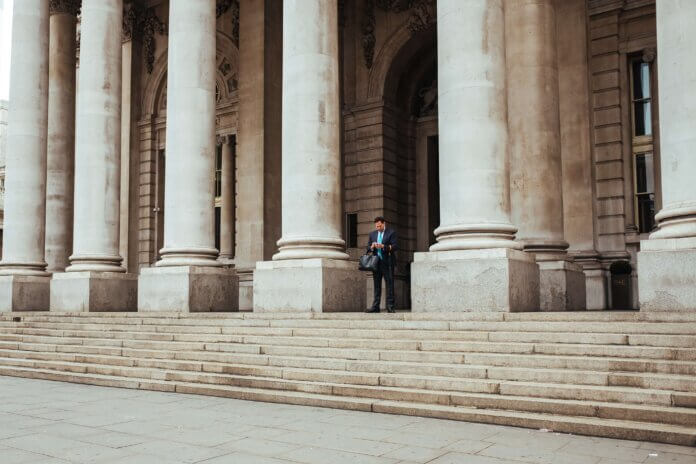 An individual getting information standing on steps outside